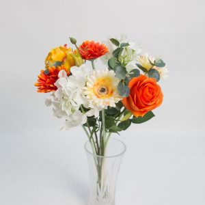bunch of mixed colourful flowers in orange, yellow and white in vase