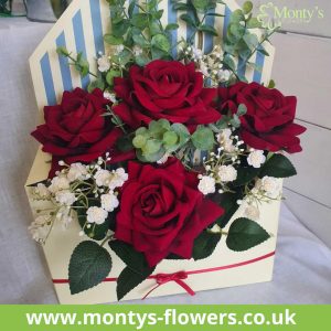 Monty's Flowers Envelope arrangement with roses, foliage and smaller flowers